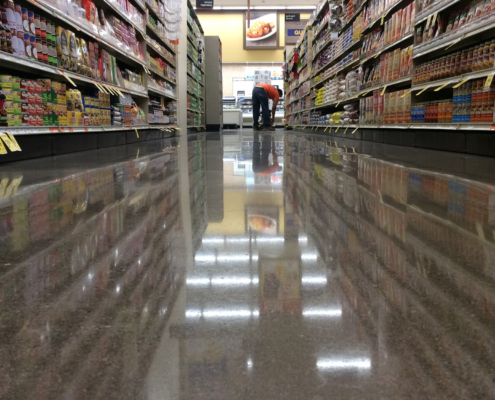 Down an aisle view, grocery store with polished floors